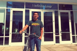 man standing holding a bike