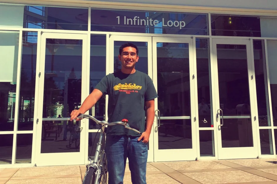 man standing holding a bike