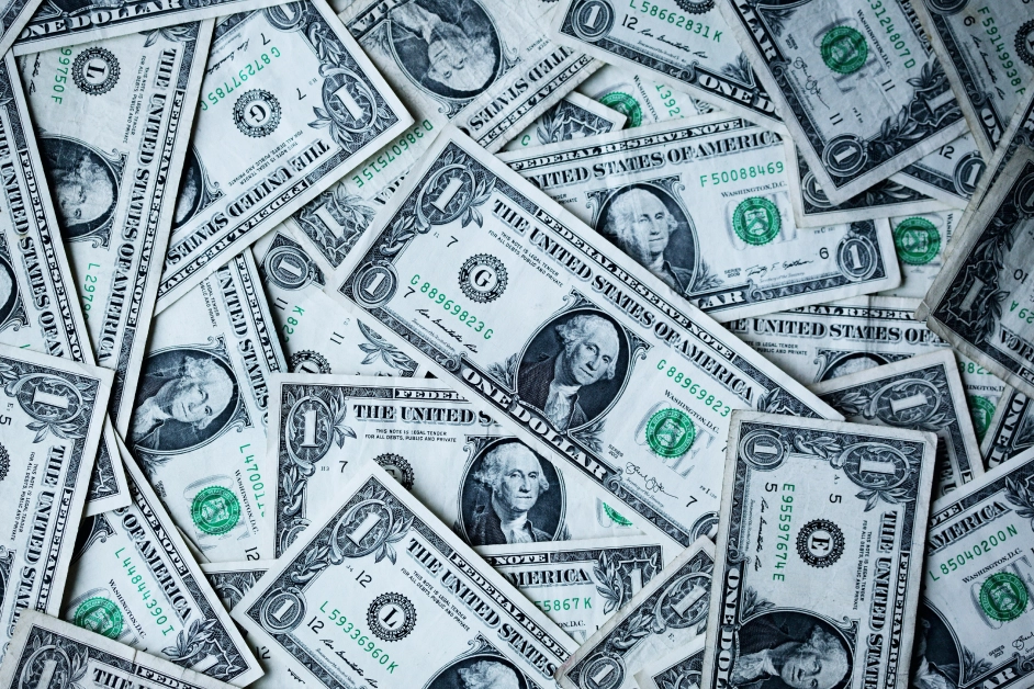 many dollar billls stacked