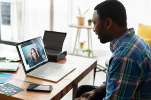 man looking at a laptop on a desk