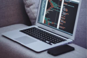 laptop with programming code on the screen