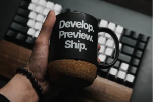 coffee mug by computer keyboard