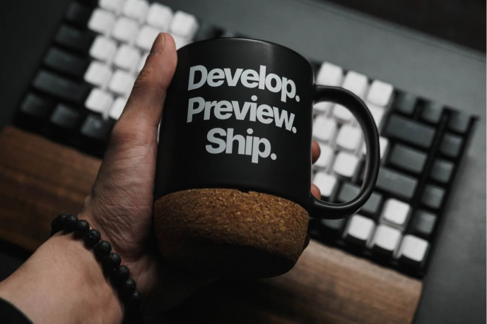 coffee mug by computer keyboard