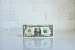 dollar bill standing on a desk