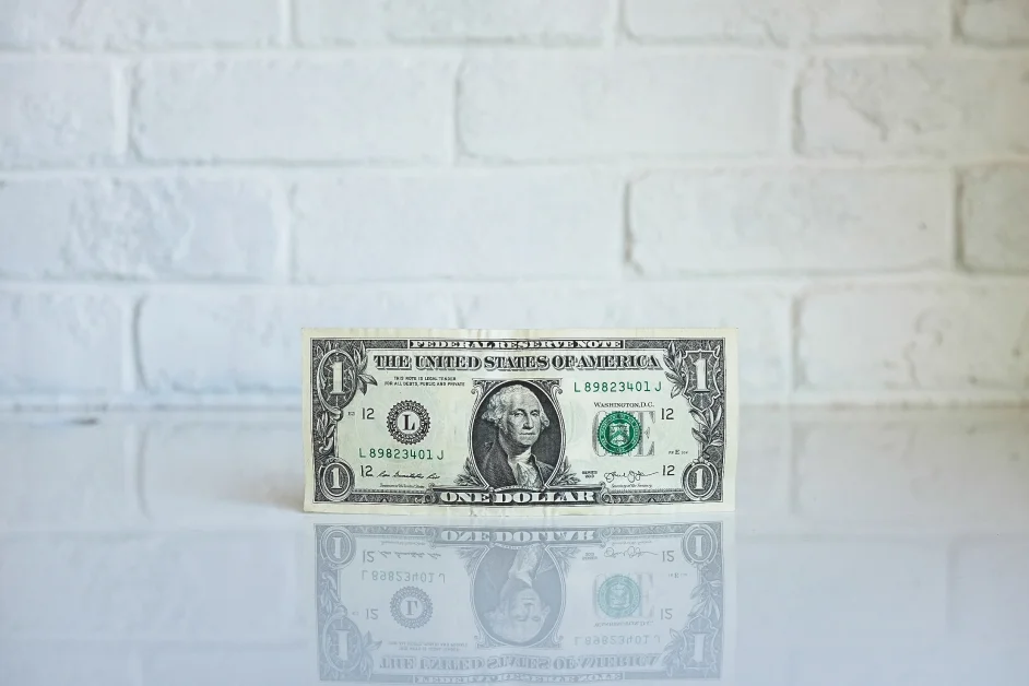 dollar bill standing on a desk