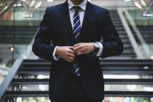 a man adjusting his suit while walking
