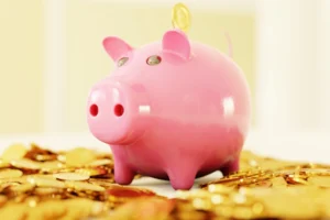 piggy bank over gold coins