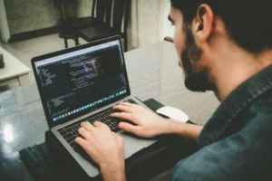 man typing on a laptop