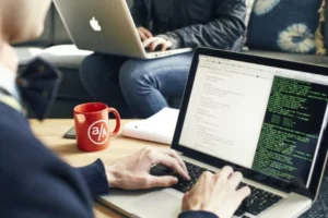 person coding on laptop