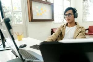 man at desk working on a computer