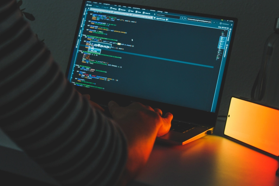 person coding on a laptop