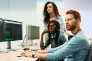 team of professionals working on a computer