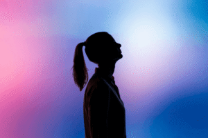 women shadow with ponytail in front of colorful background