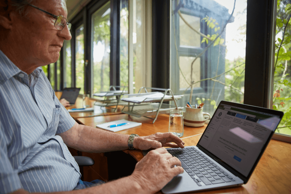 older man working on a laptop at counter